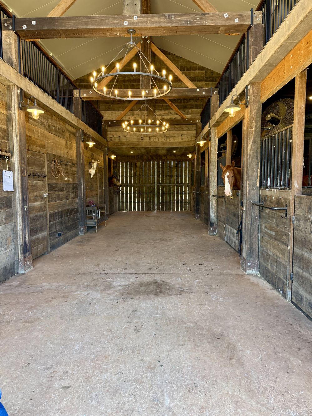 Timber stable aisle with chandeliers
